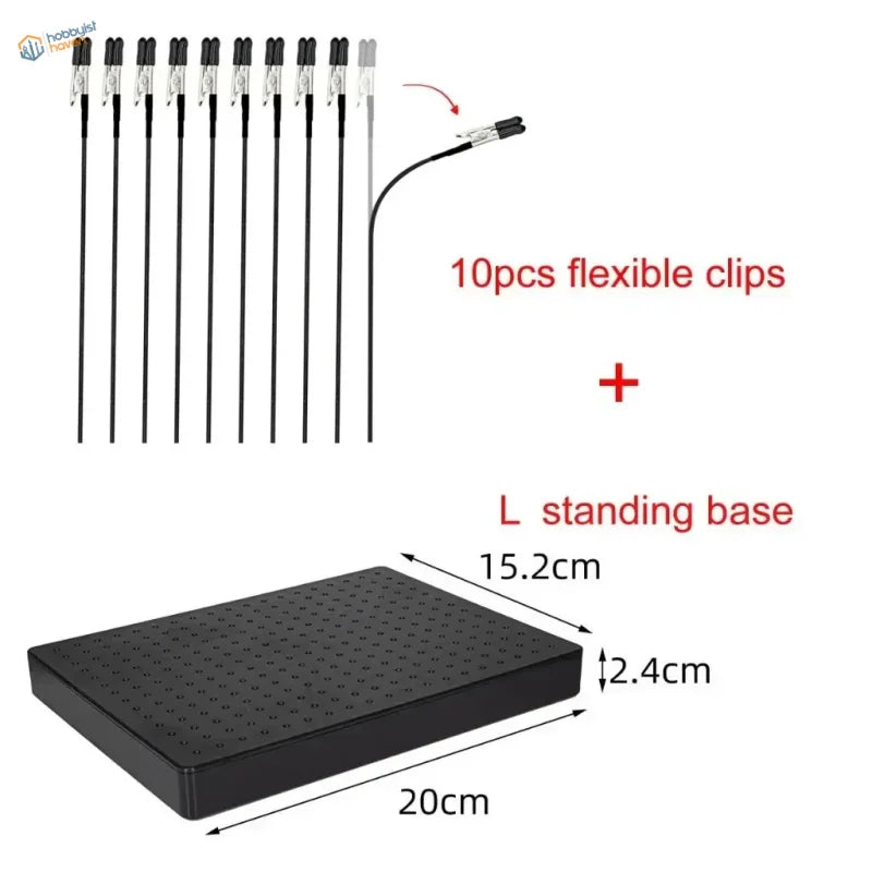 Black plastic l-shaped standing base with grid of holes for magnetic alligator clips in airbrush holder system
