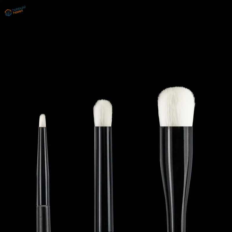 Three black-handled modeling dry brushes with white bristles