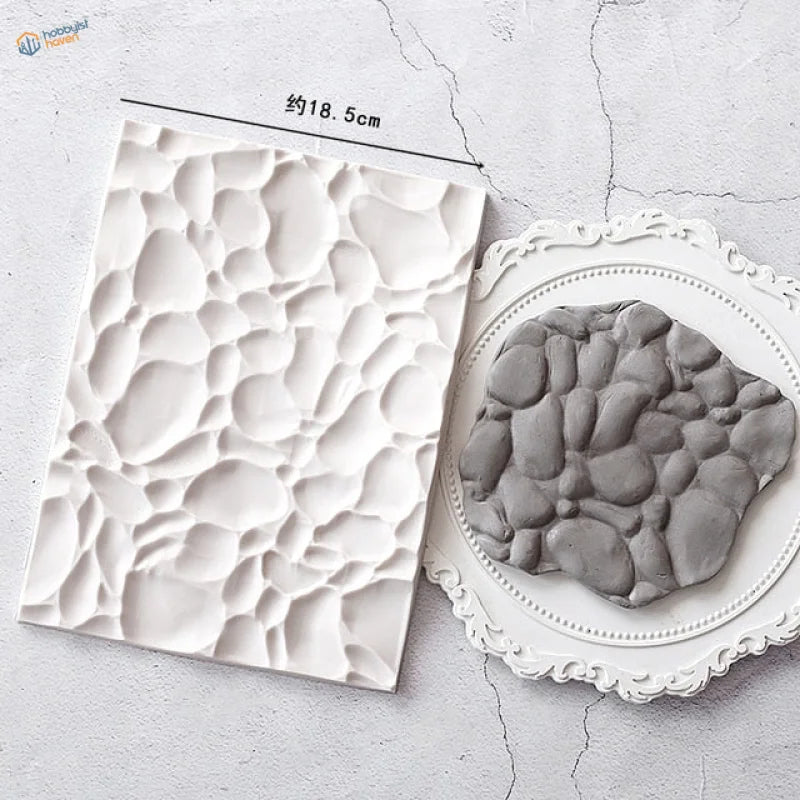 White textured stone-effect silicone mold with 3D pebble pattern for scale modeling