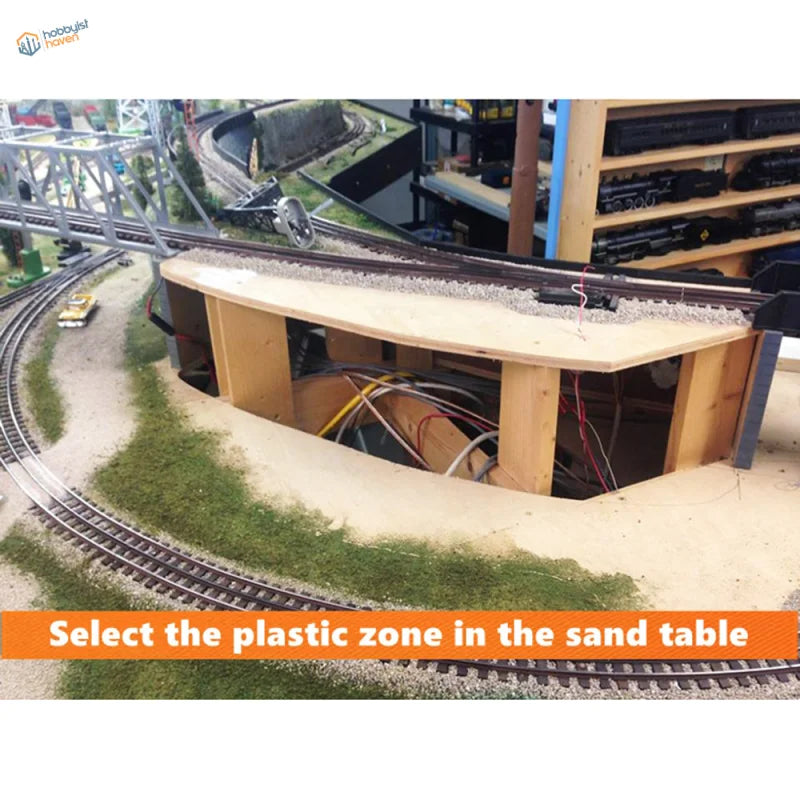 Mountain making plaster cloth with wooden model train station platform, curved edge and visible wiring