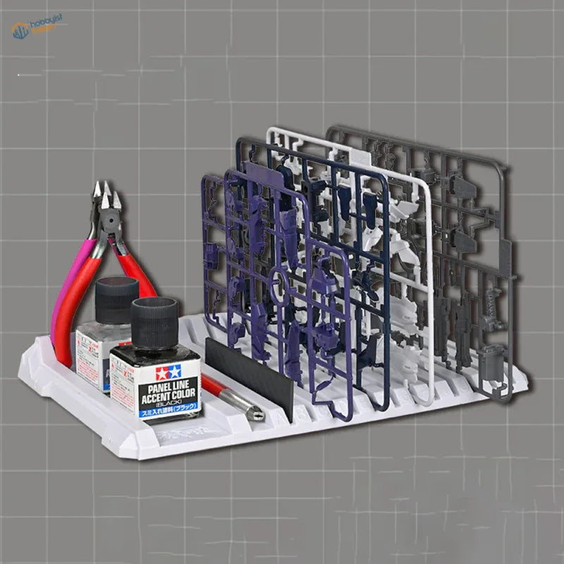 White plastic multifunctional sprue holder tray with model kit parts and tools