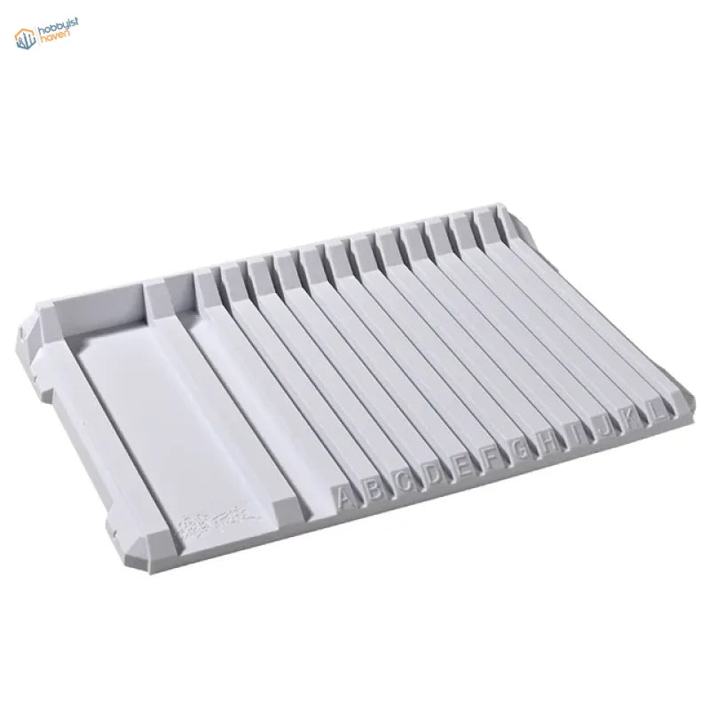 Gray multifunctional sprue holder tray with ridges and alphabet markings