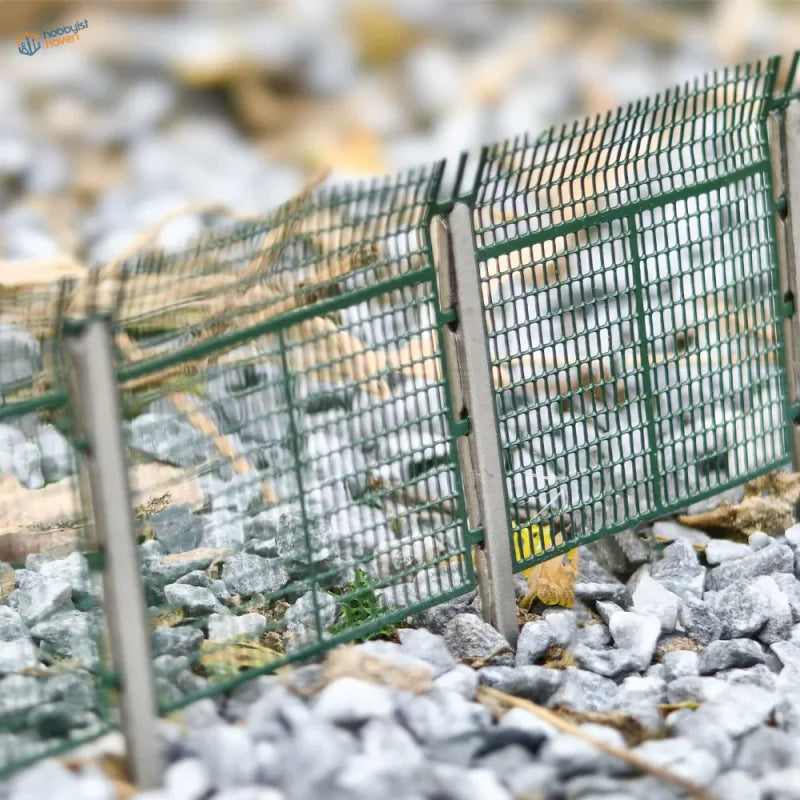 N scale green metal railway safety fence with authentic mesh-panel design and vertical posts for track protection