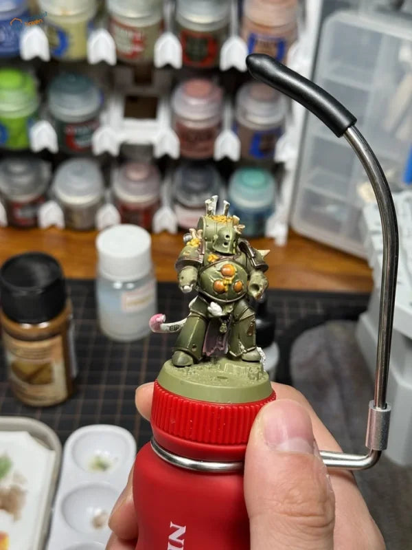 NightWorks painting handle with olive-green gold-armored miniature on red cap