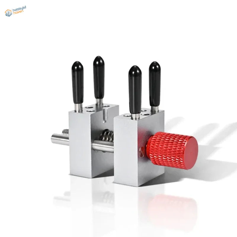 Precision micro vise with silver tool, black handles, red knob