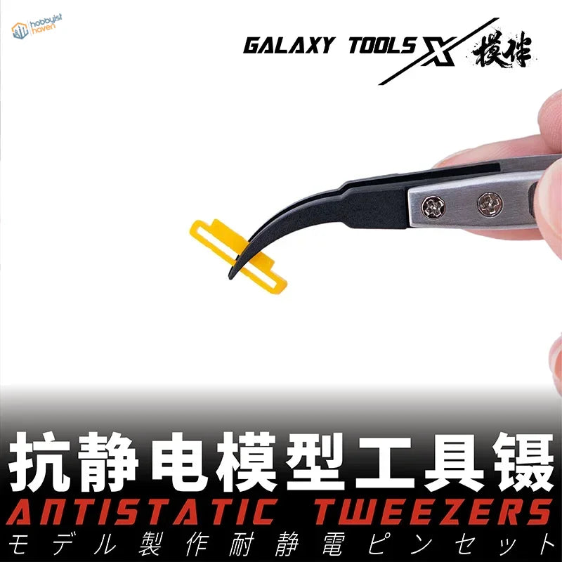 Hand holding black silver antistatic tweezers with yellow clip and replaceable chucks