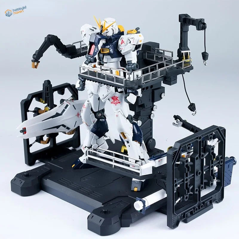 White and blue Gundam on universal platform hangar black stand