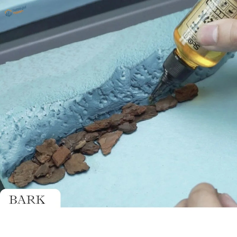 Rock-simulating tree bark for dioramas on blue base, scale modeling tool