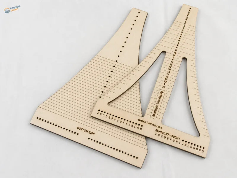 Light-colored wooden rope ladder weaving jig with engraved measurement markings and lettered guides for ladder weaving