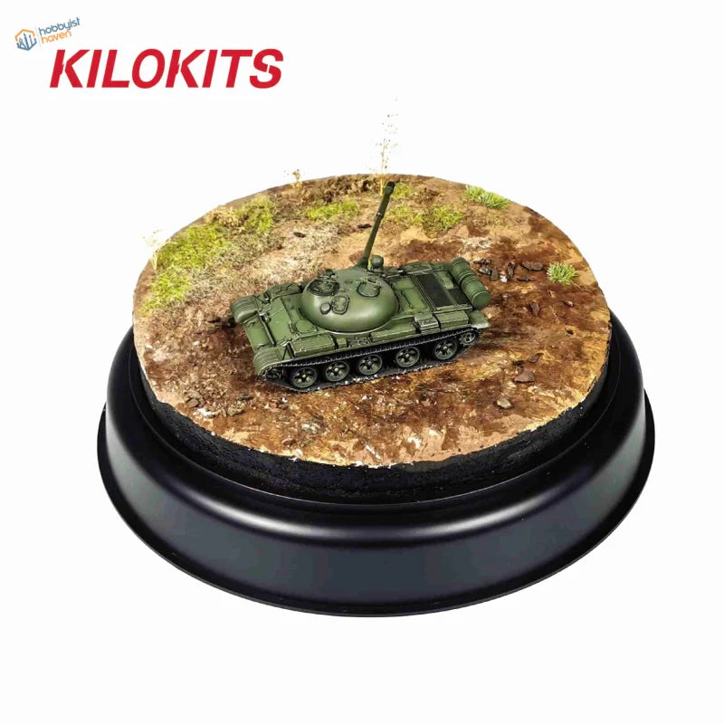 Olive green tank model on round diorama base with mossy terrain