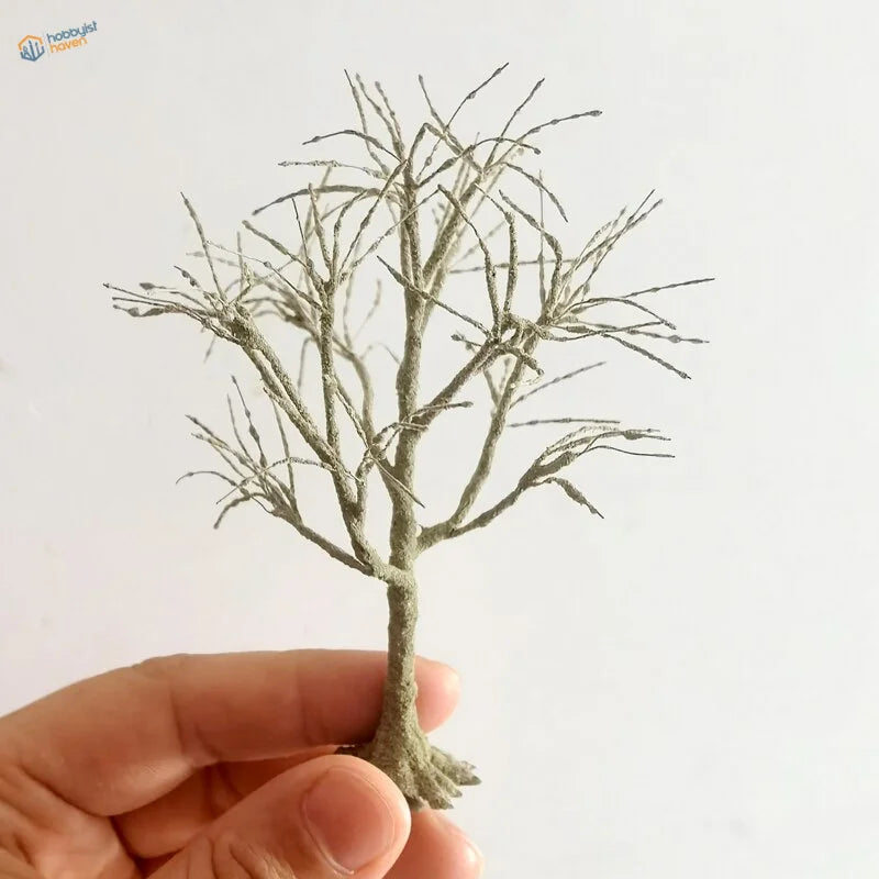 Delicate handcrafted scale model tree with grayish-green textured finish