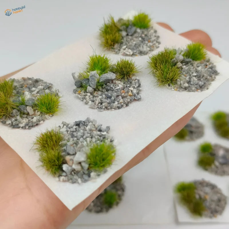 Miniature circular base toppers with green artificial grass and gray gravel for wargaming and scale modeling tools