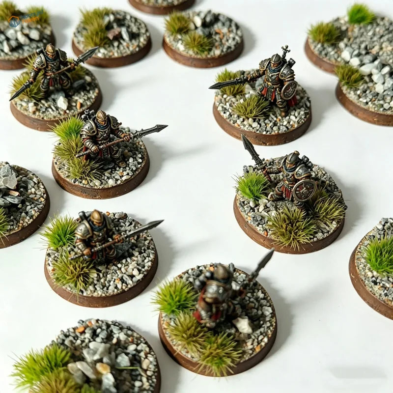 Detailed miniature fantasy warriors in dark metallic armor on scenic base toppers with gravel and grass for scale modeling tools