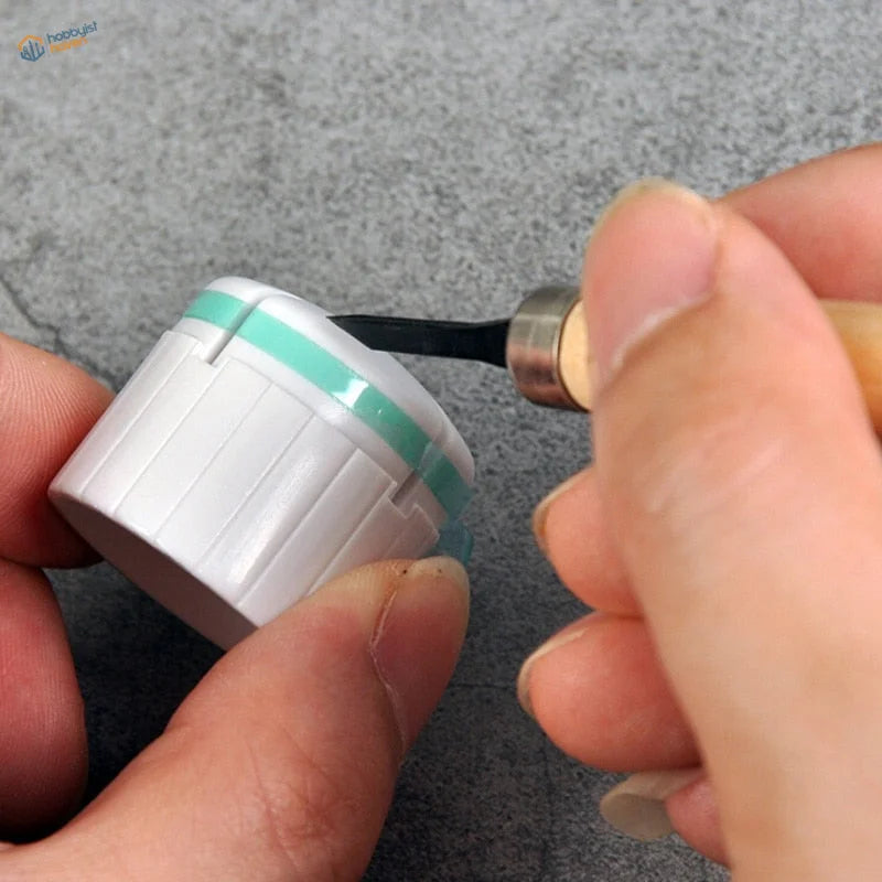 White scribing guide tape in ribbed mint green cylindrical container