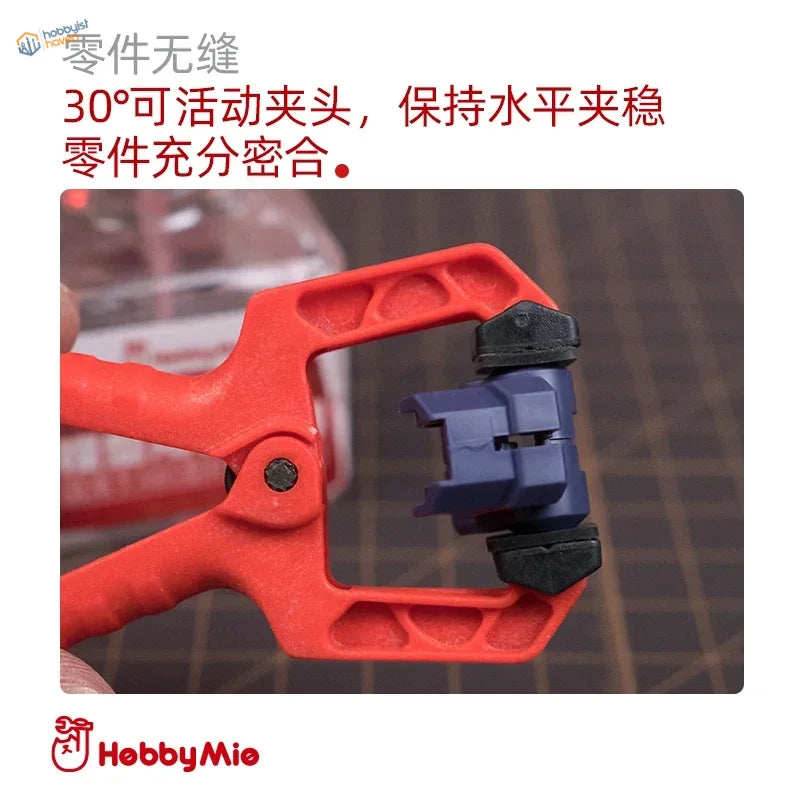 Red seamless clamp with 30-degree jaw holding blue black model parts