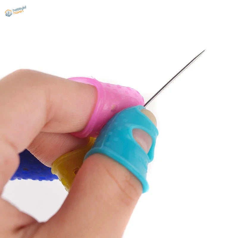 Colorful silicone finger protectors in pink, blue, yellow guard fingers holding needle