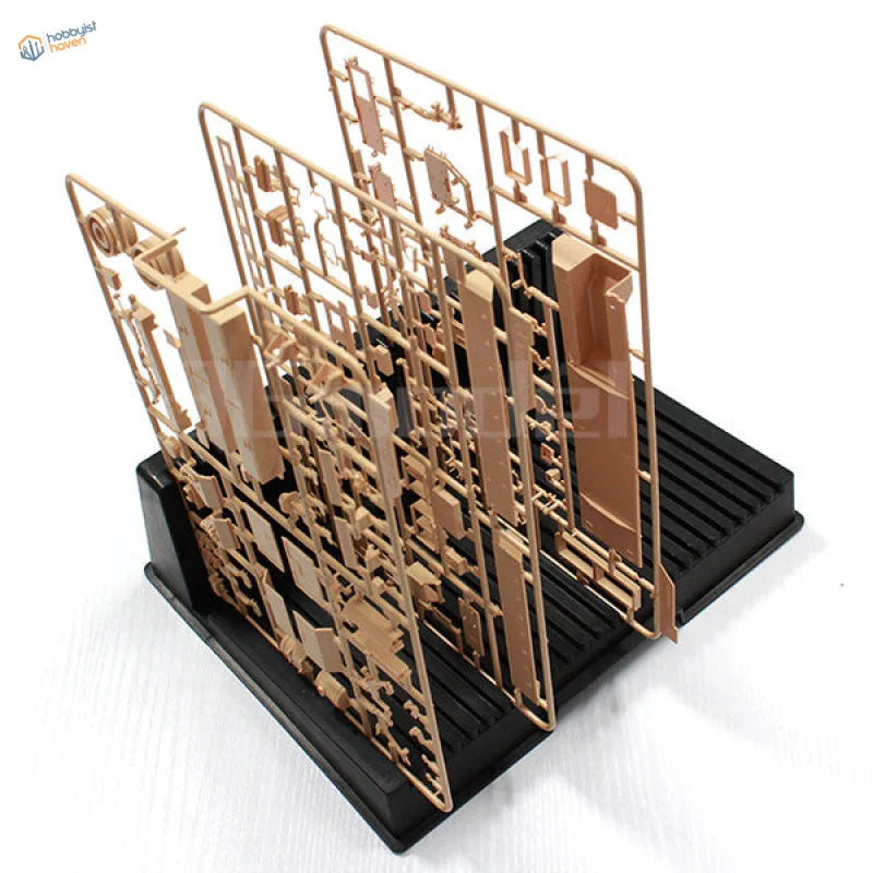 Beige plastic sprue holder parts on black stand for scale modeling tools