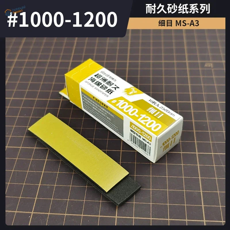 Yellow and black sponge sandpaper with a grit range of #1000-1200, packaged in a white box labeled ’sponge sandpaper’ by the brand steeldyne.