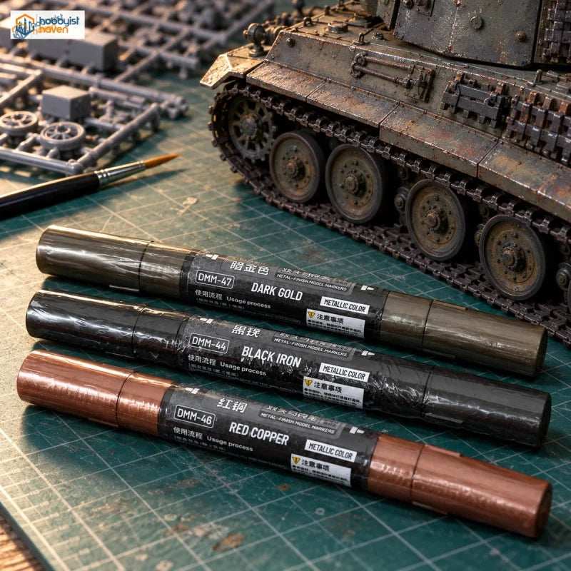 Stedi metallic markers in dark grey, black and copper in front of a weathered scale tank model