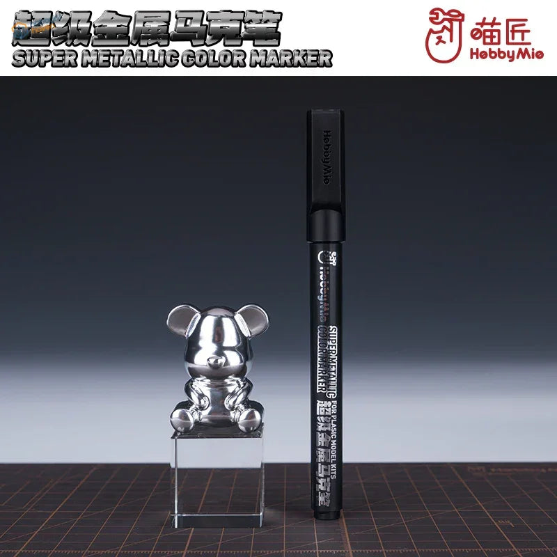Super metallic marker pens: black marker with silver cap next to chrome mouse figurine