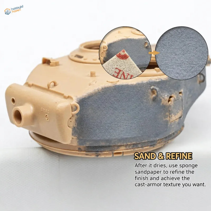 Sanding a scale model tank turret to refine the cast armor texture paste finish