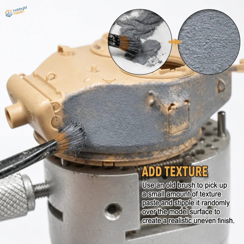 Applying grey texture paste to a scale model tank turret with a brush for a cast armor finish