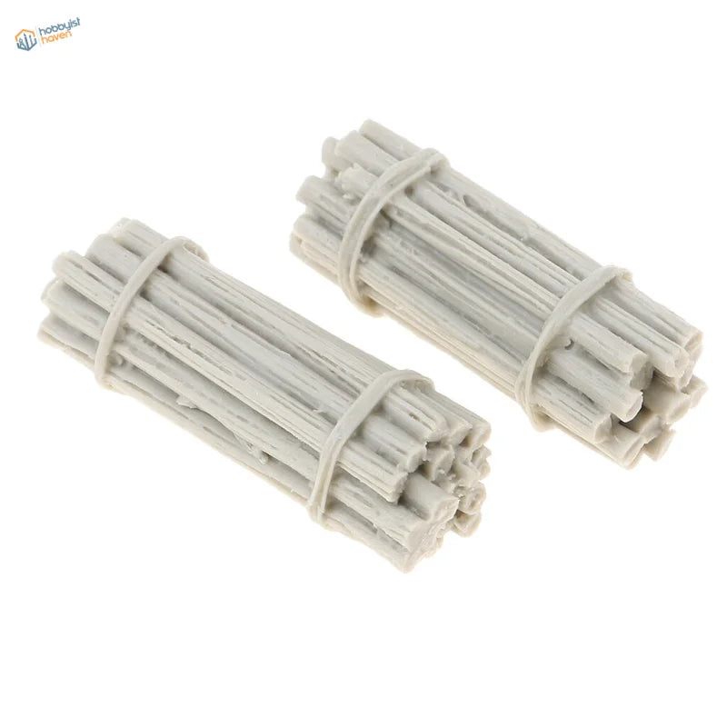 Two off-white plastic bundles of miniature sticks, each tied with a matching band.