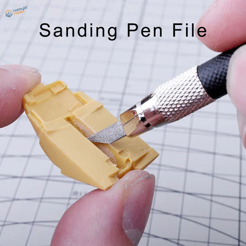 UStar sanding pen refining yellow plastic model edges with silver tip