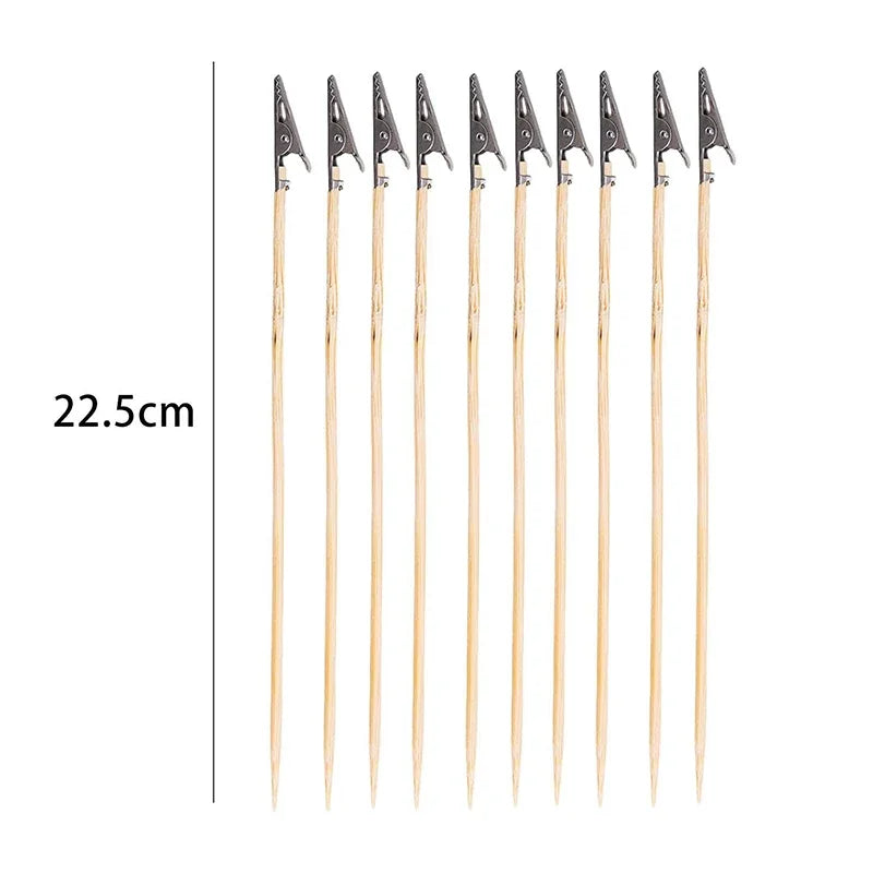 Ten wooden skewers with black alligator clips for scale modeling tools