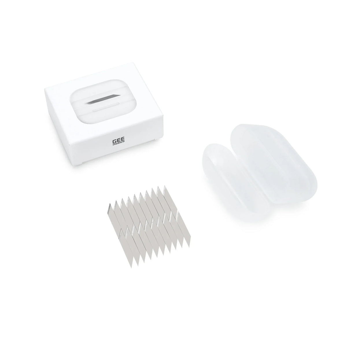 White rectangular case with transparent lid containing silver replacement blades for GeeHobby precision model pen knife
