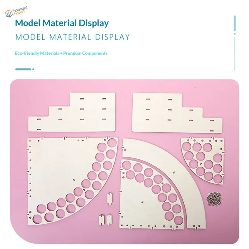 White wooden laser-cut paint bottle rack organizer parts with circular cutouts on pink mat for precision hobby tools