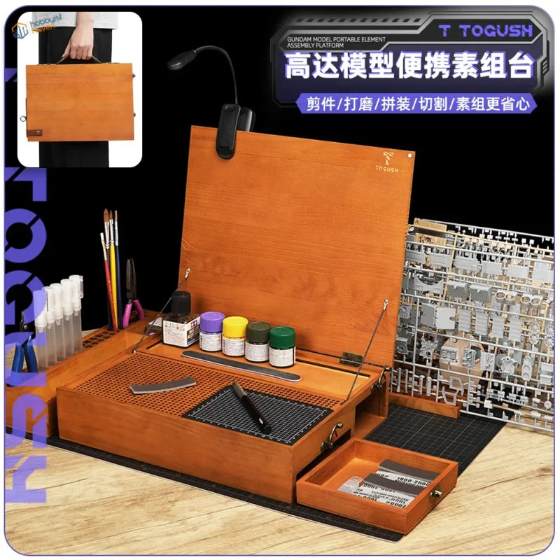 Wooden orange togush gundam model on a portable hobby station made of wood for easy assembly and portability
