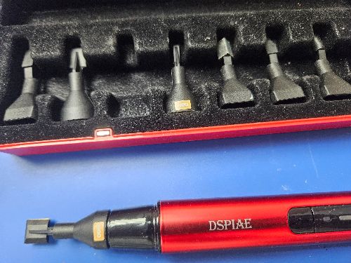 Red and black dspiae reciprocating sander precision tool with extra heads and interchangeable metal bits in a matching case