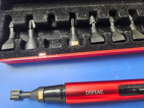 Red and black dspiae reciprocating sander precision tool with extra heads and interchangeable metal bits in a matching case