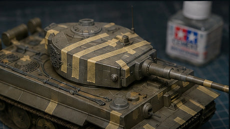 Scale model tank on a workbench with guide tape positioned for careful panel line scribing