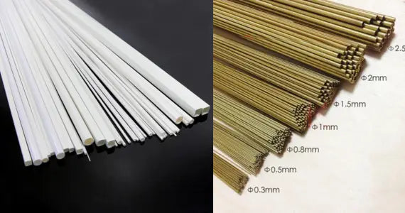 White and gold metal rods with precise diameter markings neatly arranged for scale modeling tools and precision hobby tools