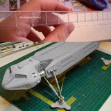 Gray plastic model spaceship with brass tubes for scale modeling