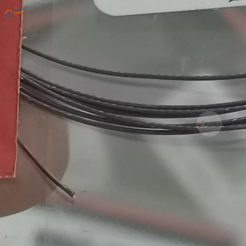 0.38mm colored stainless steel wire, black braided neatly coiled on reflective surface