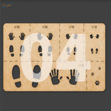 Brown cardboard paw print stencil with black gray hand foot cutouts for 1/16 to 1/72 scale models