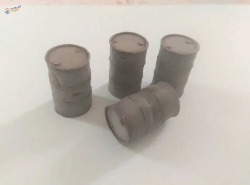 Four 1/35 resin 200L barrels: one on side, three upright