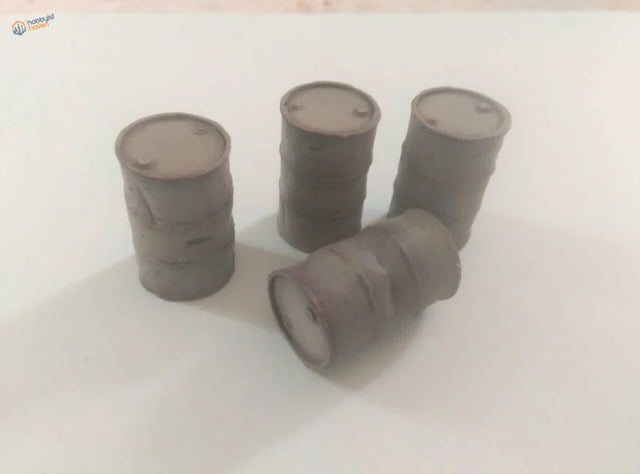 Four 1/35 resin 200L barrels: one on side, three upright