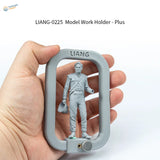 Gray plastic 1/72-1/24 figure holder for scale modeling with uniformed man figure