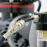 Silver metallic air hose connector with knurled texture attached to black braided airbrush hose tubing