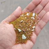Hand holding 10/30g grass rocks for model making dioramas