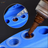 Blue silicone mold filled with brown liquid using syringe from disposable paint cups