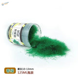 125ml bottle of 10-13mm long static grass with green fibers spilling out