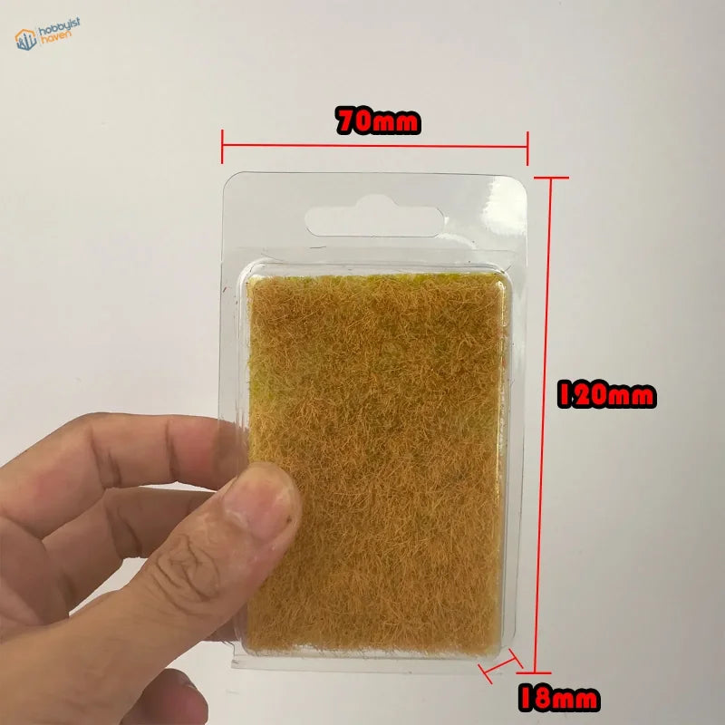 12mm static grass tufts with golden-brown scrubbing pad in clear blister pack