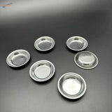 Six shiny 12pcs stainless steel pie pans on dark surface