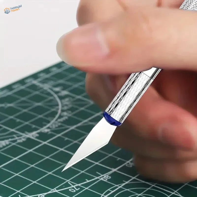 Silver-handled precision craft knife with a sharp, metallic blade and blue accent cap.