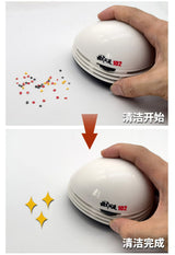 Mini desktop vacuum cleaner white egg-shaped with red branding